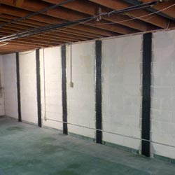 Carbon fiber straps adding strength to a foundation wall