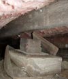a rotting crawl space support that has failed to hold up a home