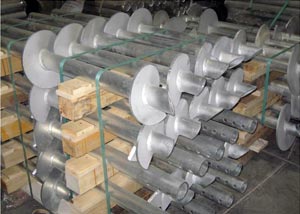 galvanized steel helical piers awaiting installation in a warehouse