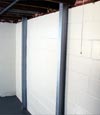 an installed I-Beam system bracing a foundation wall
