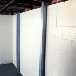 I-beam wall braces installed along a failing foundation wall