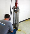 a contractor installing a push pier inside a home.