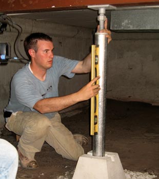 a contractor installing a crawl space jack post