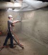a contractor applying shotcrete to a failing foundation wall
