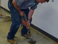 a contractor coring a hole in a foundation slab